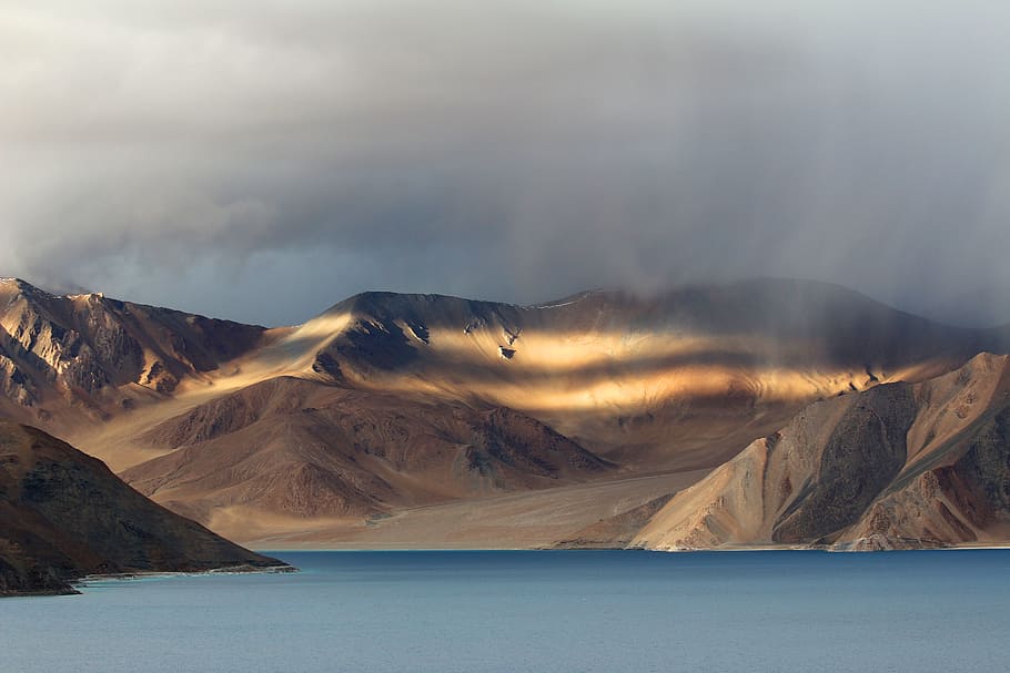landscape photo of brown mountains, brown mountain near body of water HD wallpaper