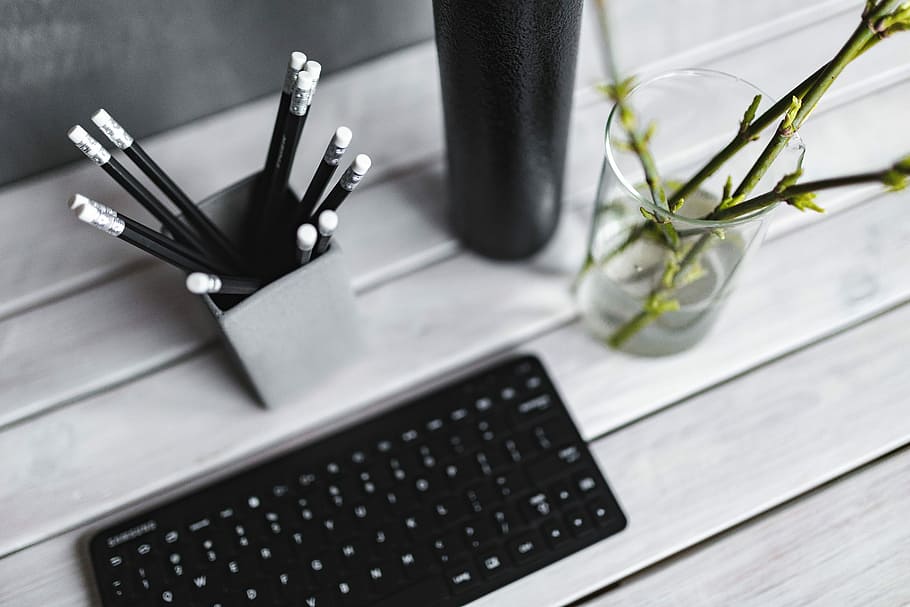 Black keyboard with pencils on a white table, bottle, plant, wood - Material HD wallpaper
