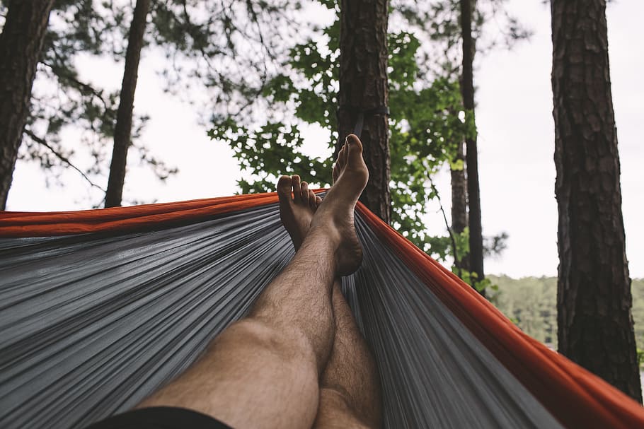 person in black bottoms in hammock raise his feet, man, foot HD wallpaper