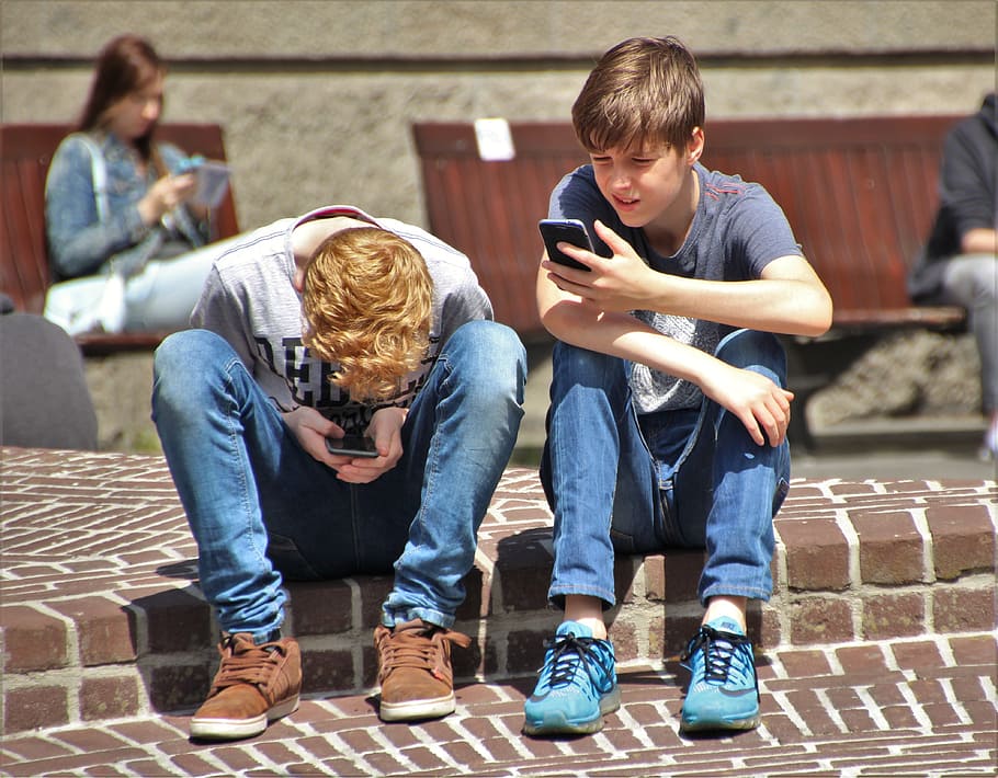 two boy sitting on brown brick pavement taken during daytime, HD wallpaper