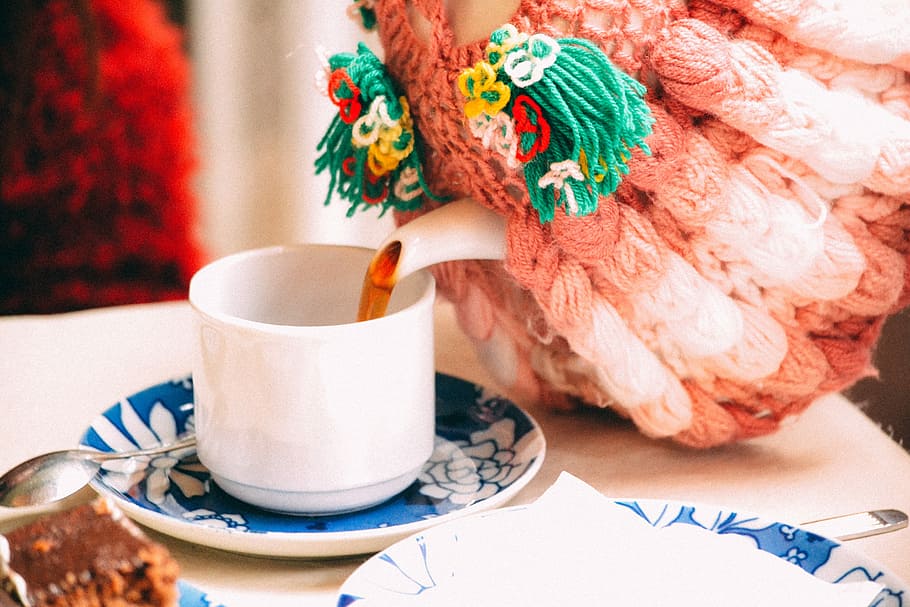selective focus photography of person pouring teacup, person pouring tea on white ceramic cup on table HD wallpaper