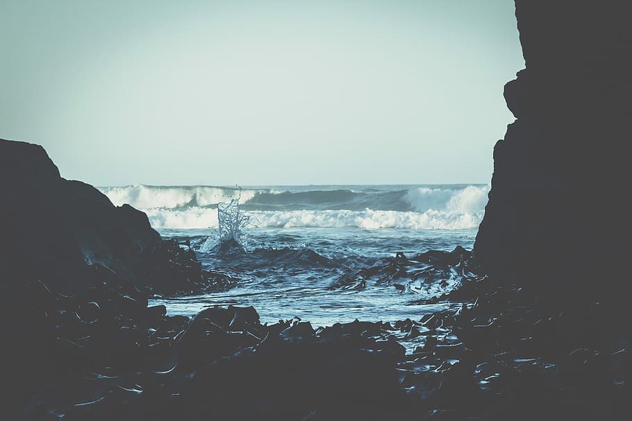 landscape photography of seashore and cave, ocean waves on seashore at daytime HD wallpaper