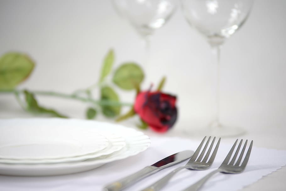 three round white ceramic plates near silver bread knife and two forks HD wallpaper
