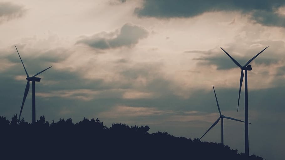 three wind turbines on mountain, silhouette of windmills, wind farm