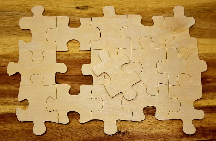 puzzle on wooden board, last part, joining together, insert, share