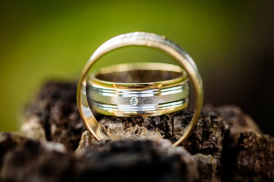 two gold-colored wedding rings on brown surface, shallow, focus HD wallpaper