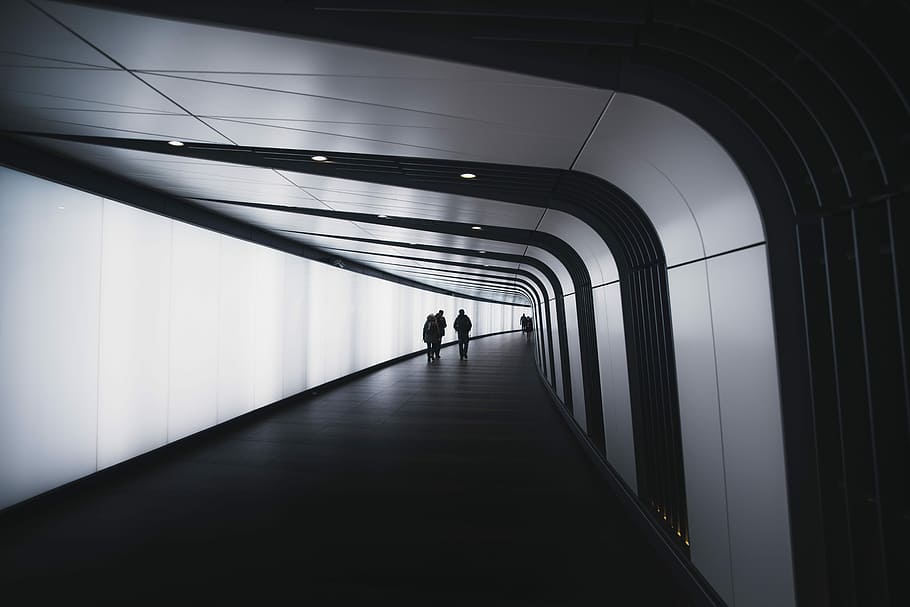 three people walking on corridor, people walking narrow pathway HD wallpaper