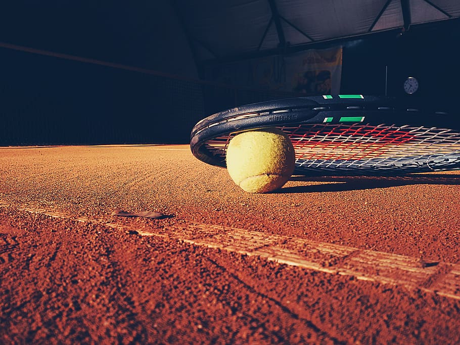 black Wilson tennis racket on surface, court, clay, ball, sports