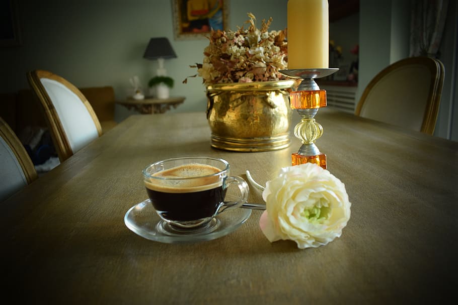 coffee in glass cup beside white rose and candle holder on dining table HD wallpaper