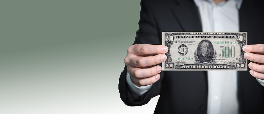 person showing 500 US dollar banknote in selective focus photography HD wallpaper