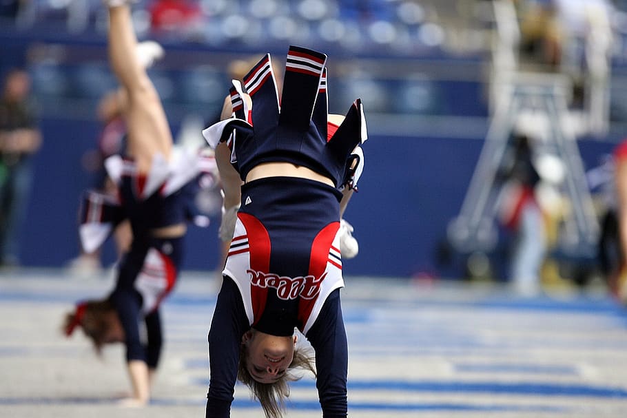 woman posing for cheering during daytime, cheerleader, somersault