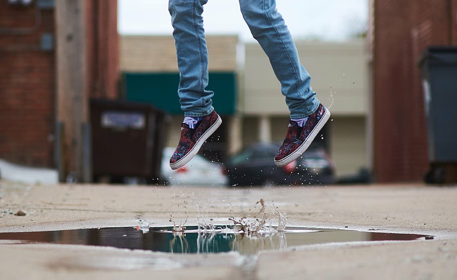 person over puddle of water, girl, jump, jumping for joy, young