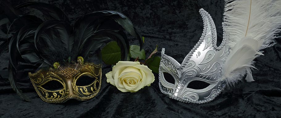 photo of gold and silver mask beside white rose flower, carnival