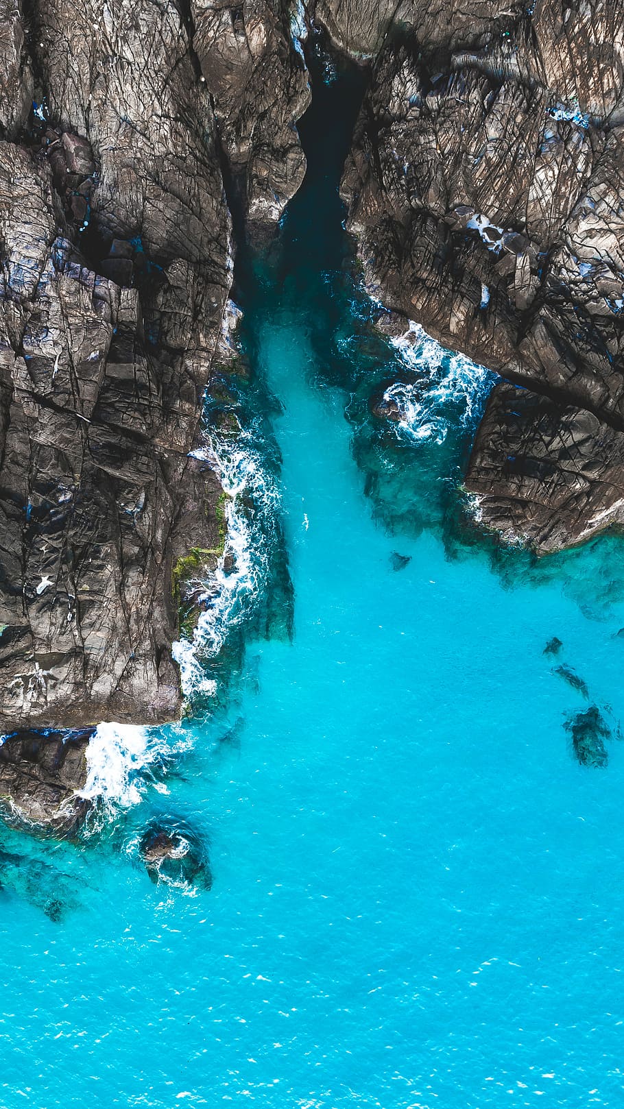 aerial photography of body of water beside cliff during day, aerial view of mountain and body of water HD wallpaper