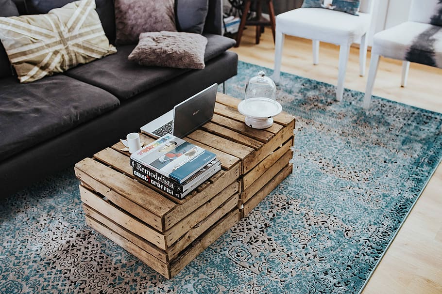 Designer living room interior with a wooden box table and a light blue carpet