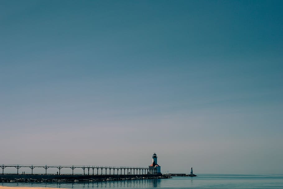 white and brown lighthouse tower under blue skies, white lighthouse beside a body of water HD wallpaper