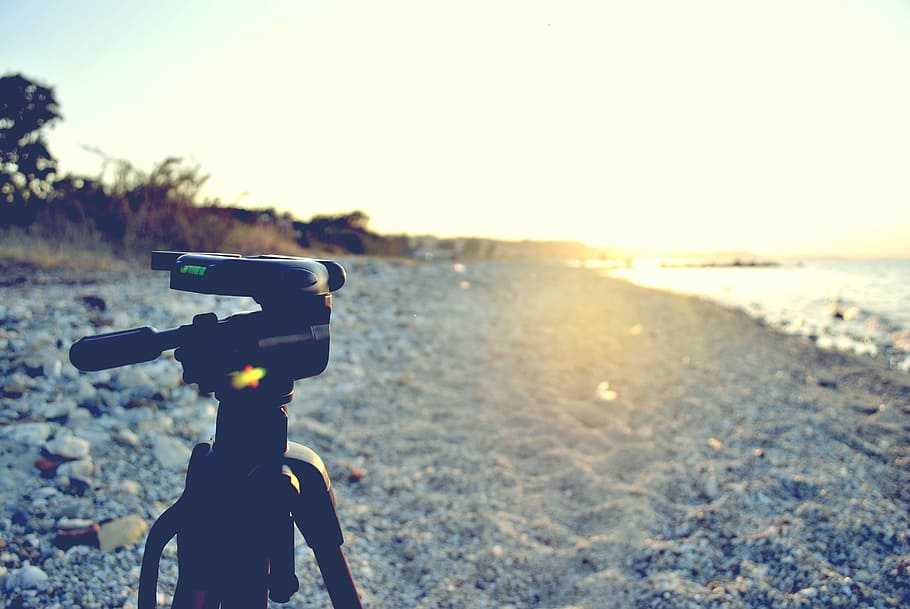 black tripod stand near shore during daytime, black tripod on sands near body of water HD wallpaper