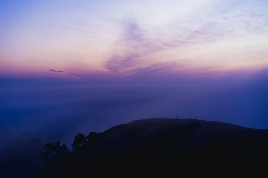 silhouette of mountain under purple sky, photo of person standing on mountain HD wallpaper