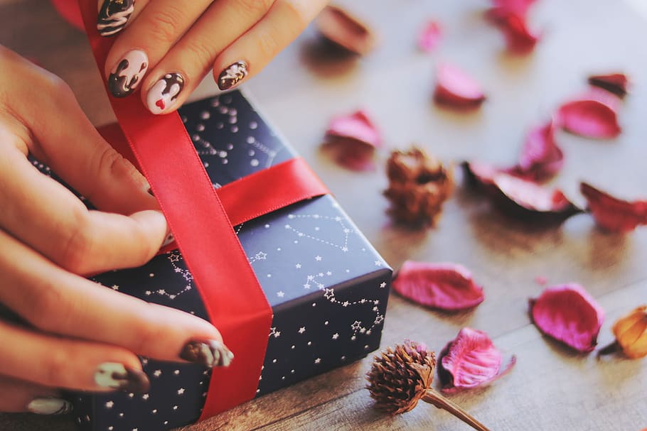 human's hand holding red ribbon while wrapping a blue box, women HD wallpaper