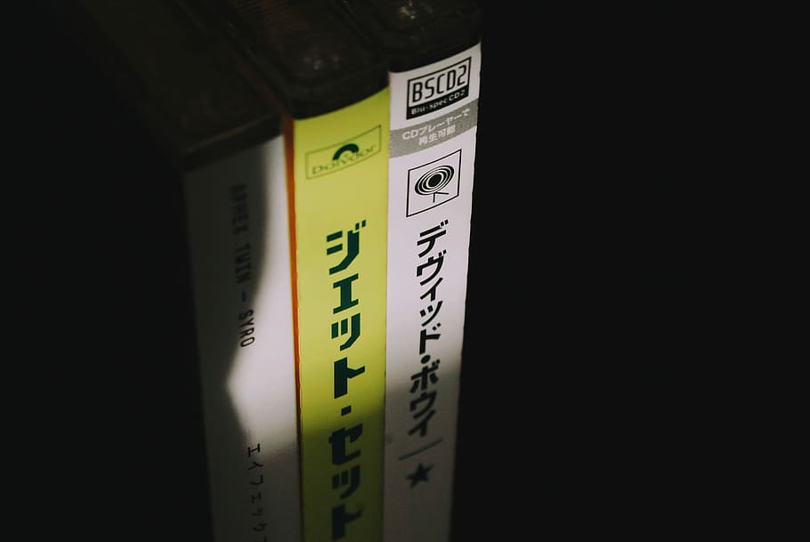 kanji script, closeup photo of three disc cases, cd, cvd, music HD wallpaper