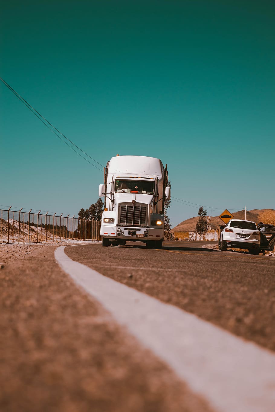 white freight truck on grey concrete road, white freight truck beside white SUV on road HD wallpaper