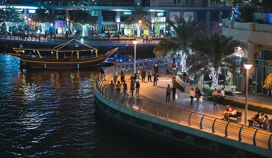 group of people standing on plaza near body of water, dubai, dubai marina