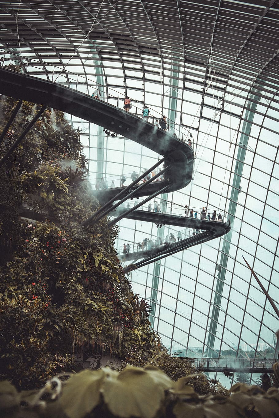 person inside a glass dome on a huge mound with stairs, people standing on metal pathway near man made mountain inside dome building HD wallpaper