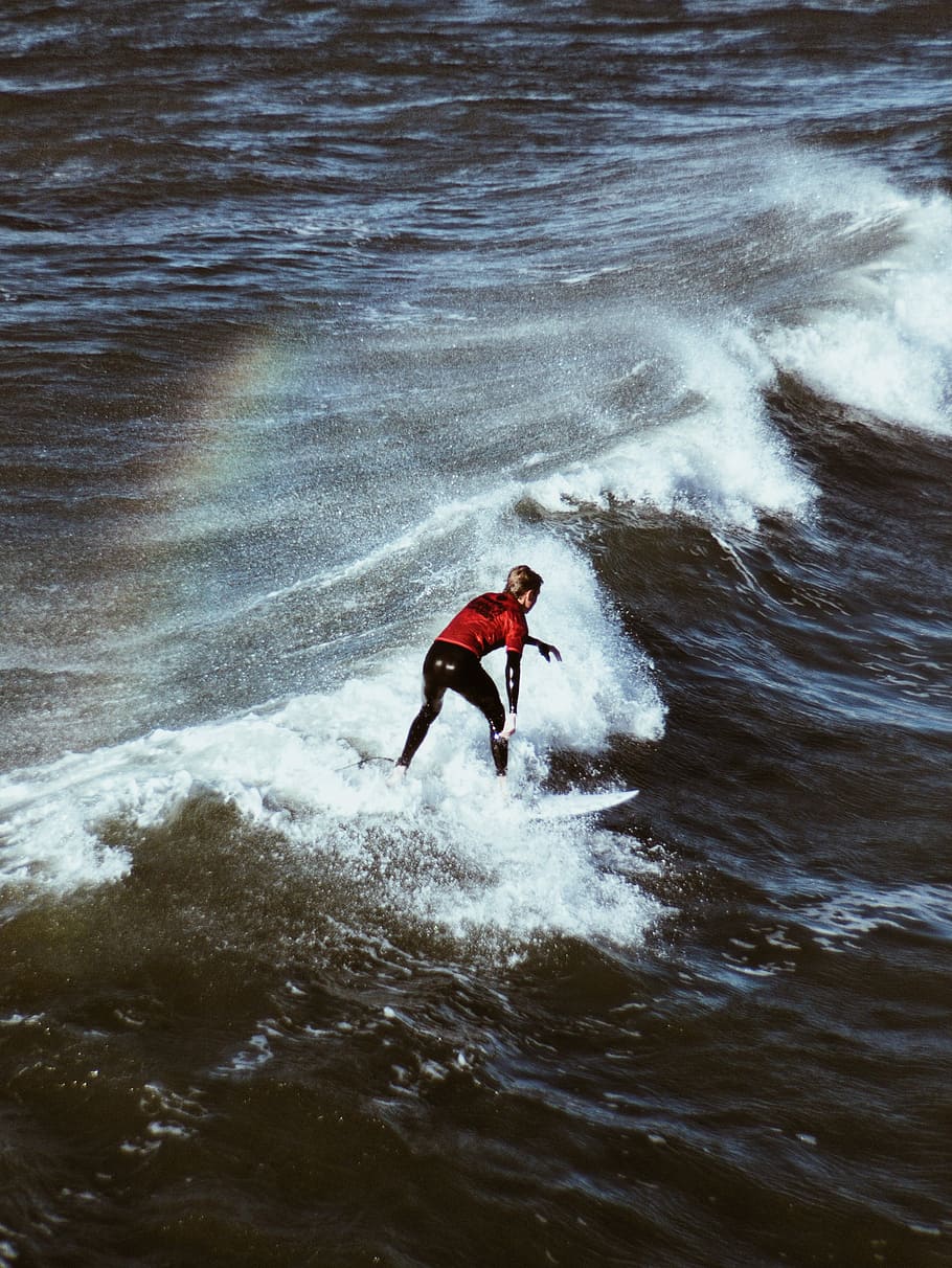 man riding surfboard on sea waves, woman riding on surfing board making tricks HD wallpaper
