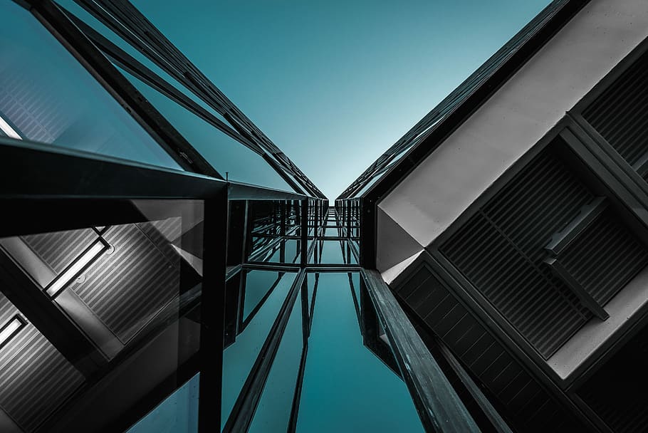 low-angle photography of building, low-angle photograph of high-rise building under clear blue sky HD wallpaper