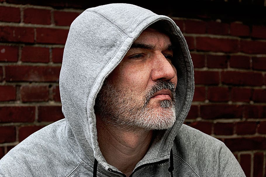 man in gray hoodie jacket looking in his left side, profile, portrait