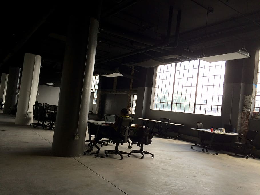 man sitting on chair facing table inside building, person sitting on chair inside room HD wallpaper