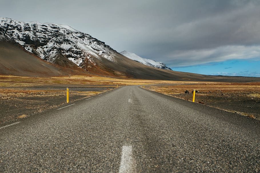 asphalt road through mountain, gray, concrete, clouds, highway HD wallpaper