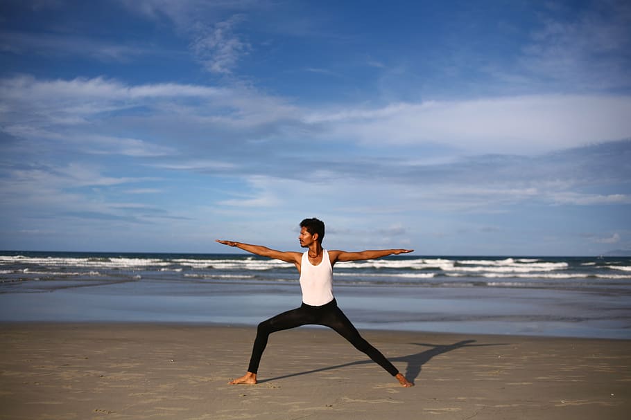 man wearing white tank top with black pants, yoga, indian, yoga guy
