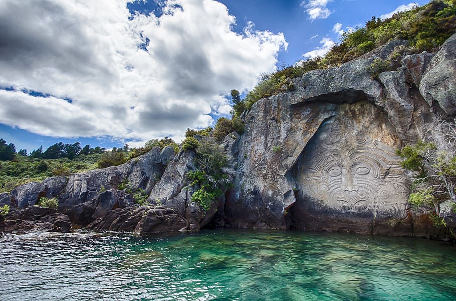 stone wood carving during daytime, new zealand, mural, maori