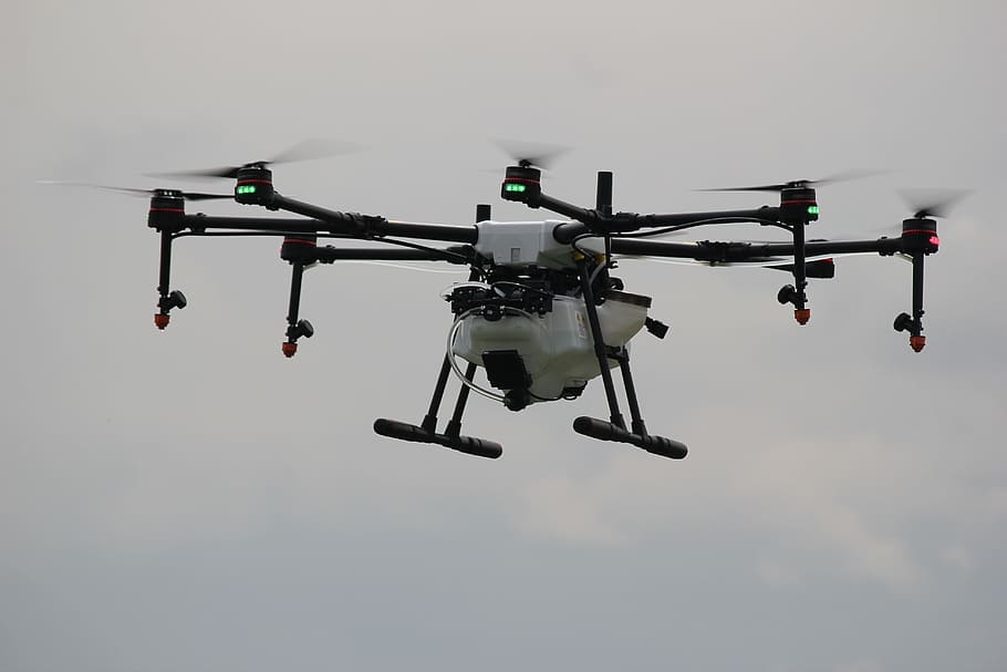 flying white and black drone under clouded sky, technology, drone farm