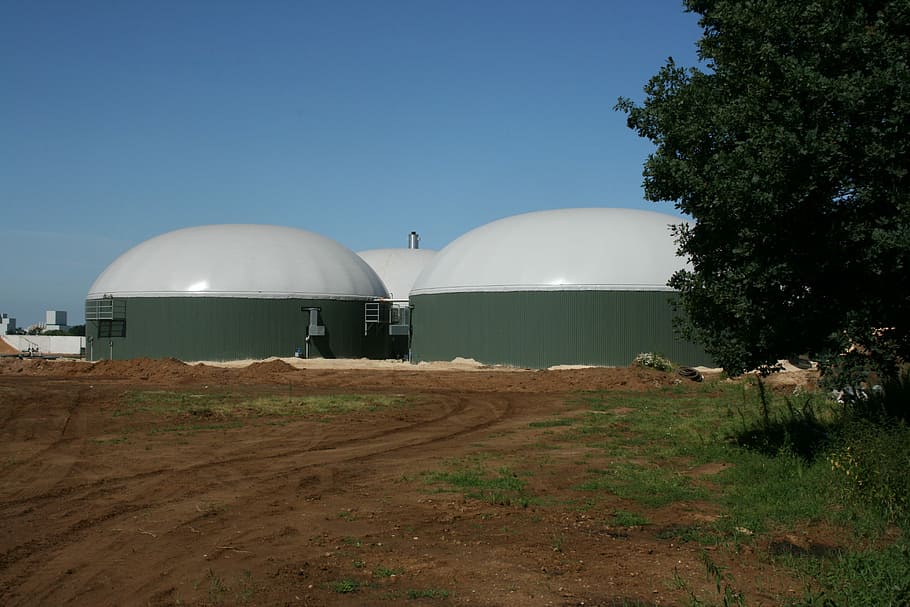 close-up photo of white and grey dome buildings, Biogas, Manure