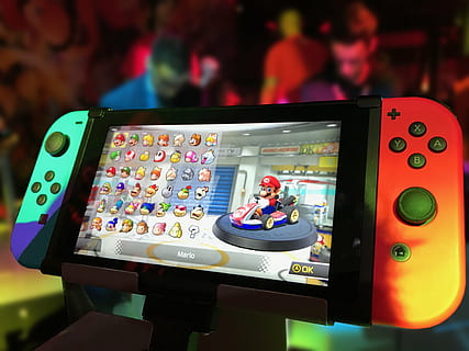 turned on Nintendo Switch with Joy-Con and Super Mario game display HD wallpaper