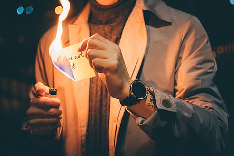 low light photography of person holding paper with flame, person burning paper holding disposable lighter HD wallpaper