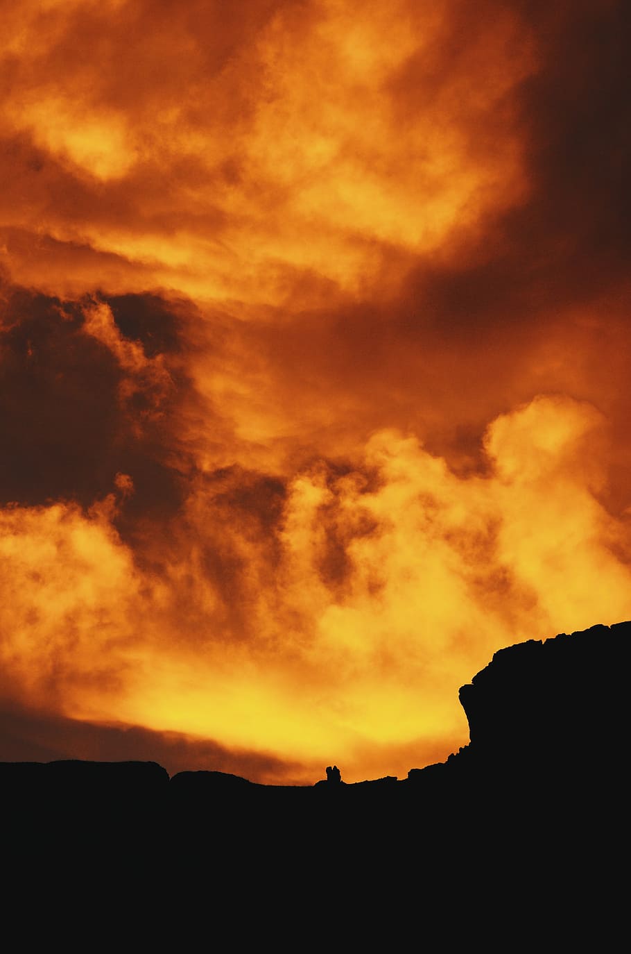 silhouette photography of hill under red sky, silhouette of rock formation under cloudy sky HD wallpaper