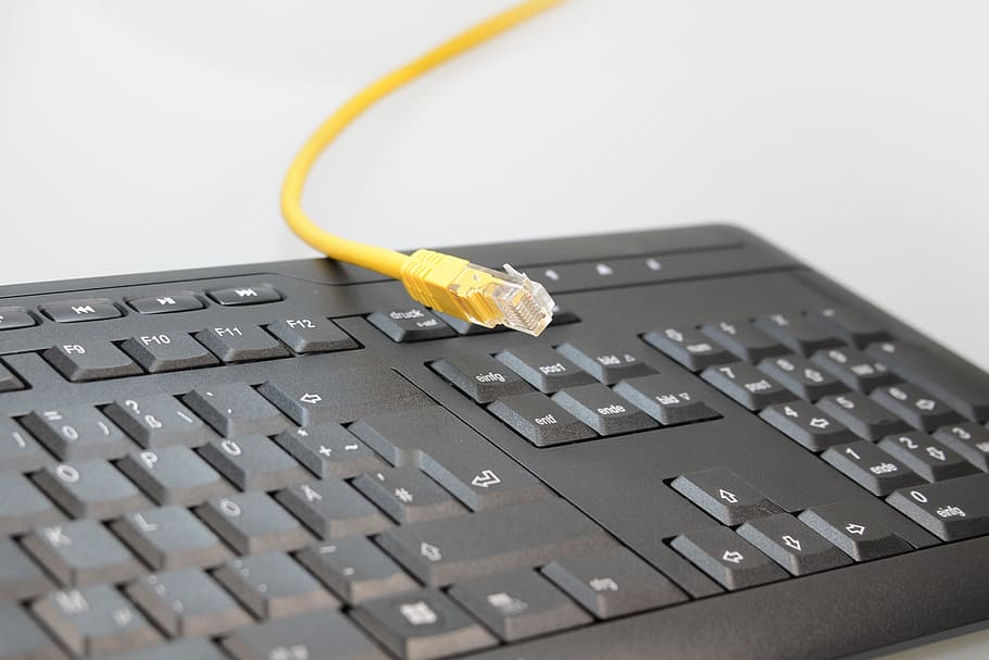 yellow UTP cable on black computer keyboard, Hardware, Patch Cable
