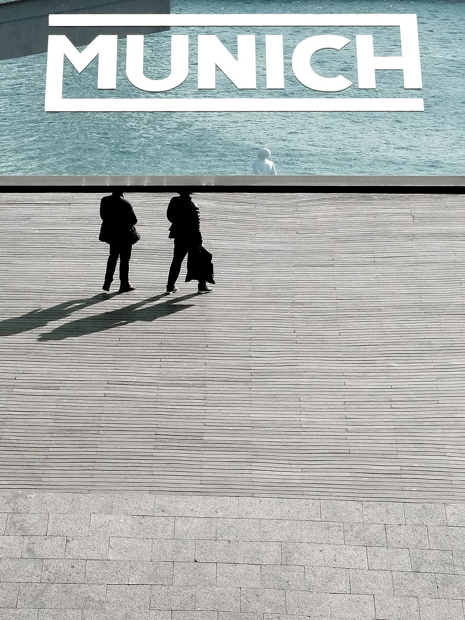 two person standing near body of water, Munich advertisement HD wallpaper