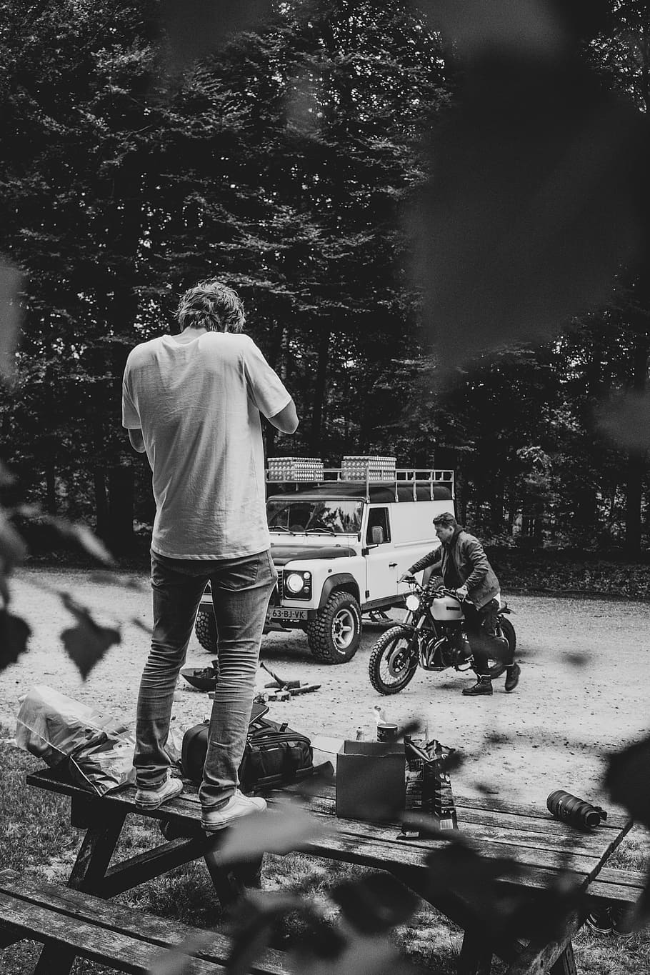 grayscale photography of man standing on picnic table, grayscale photo of man standing on picnic table HD wallpaper