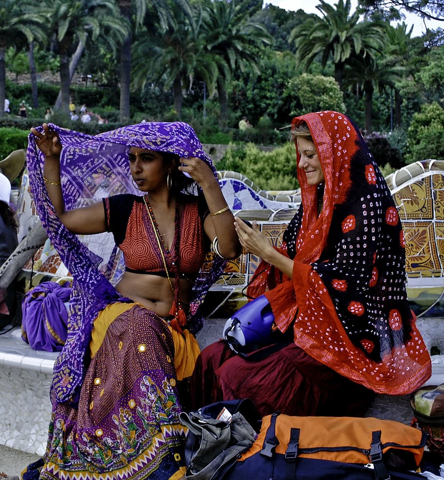 two women wearing assorted-color shawls o, barcelona, sitting