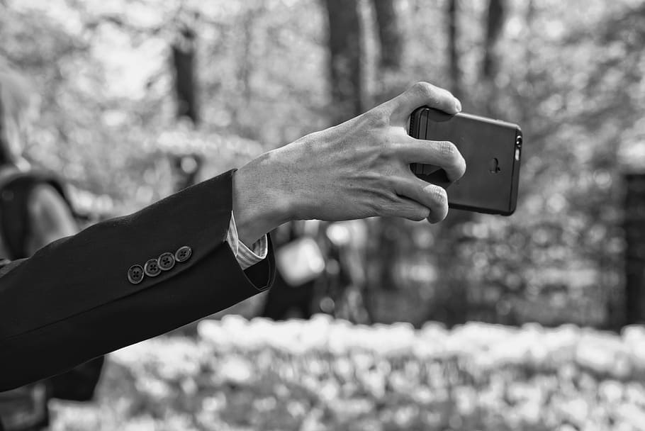 grayscale photo of man's arm holding smartphonje, hand, finger HD wallpaper