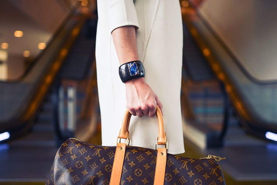 Download Look cool with a Louis Vuitton bag Wallpaper