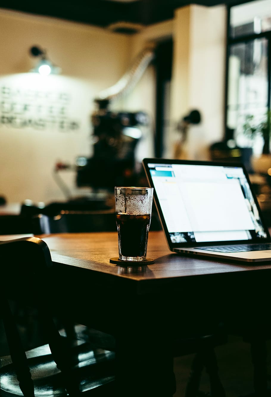 clear highball glass filled with black fluid on tabletop, selective focus photography of laptop beside drinking glass on table HD wallpaper