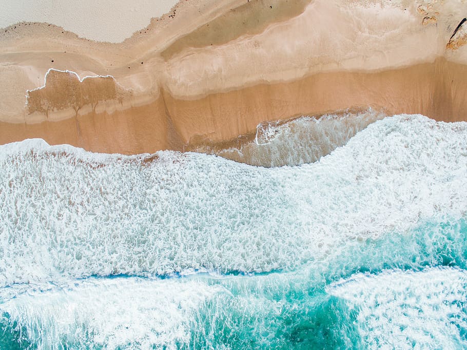 aerial photo of shoreline, body of water splashing on brown rock HD wallpaper