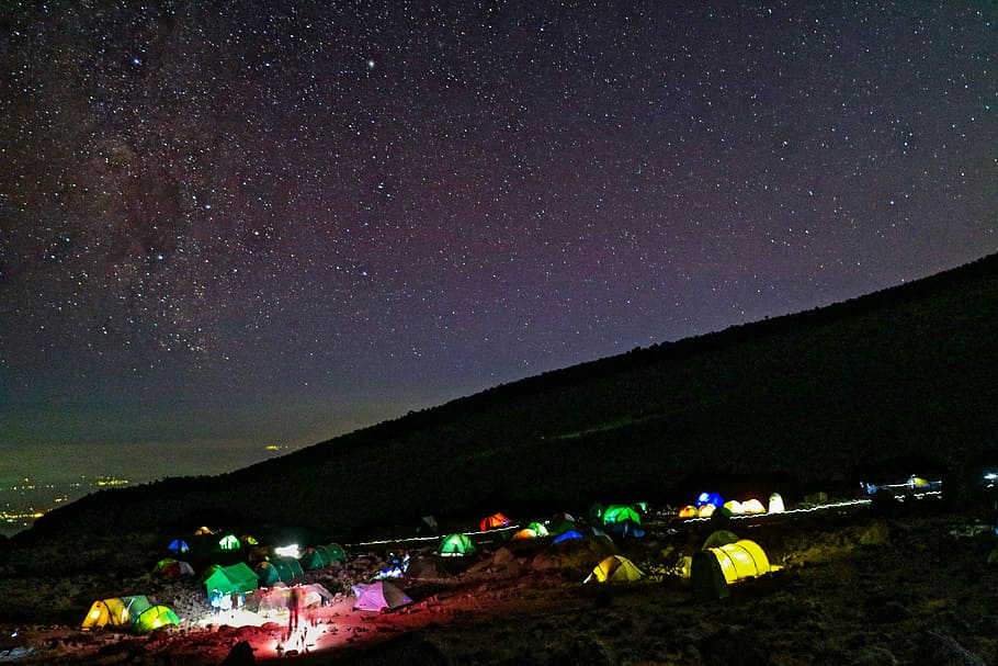tents on hill, aerial photography of lighted camping tents under gray sky during nighttime HD wallpaper