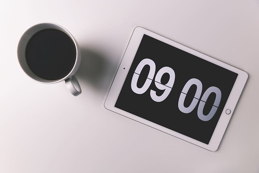 Cup of coffee and iPad with digital clock displaying the morning time, HD wallpaper