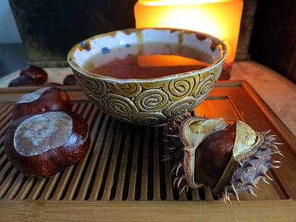 brown ceramic bowl, autumn, tea, chestnuts, candle, light, chinese bowl HD wallpaper